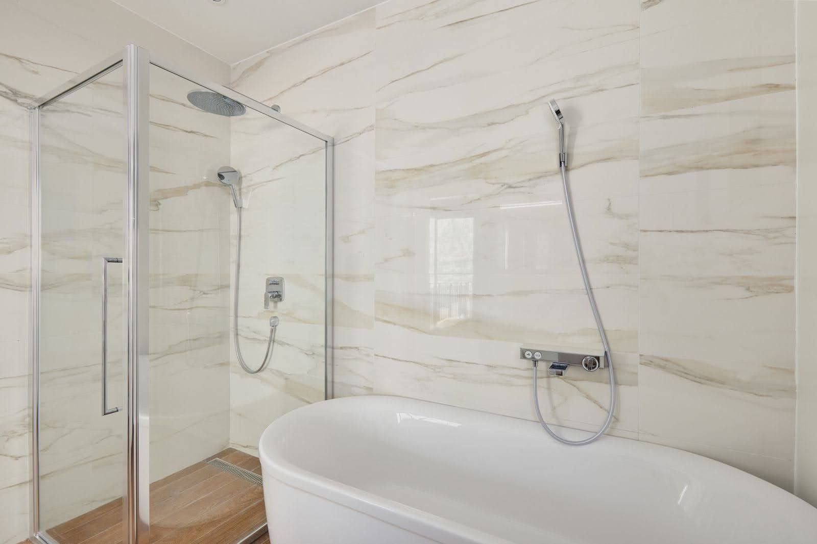 Modern bathroom with a shower cabin and a freestanding bathtub in a villa, Prčanj, Montenegro.