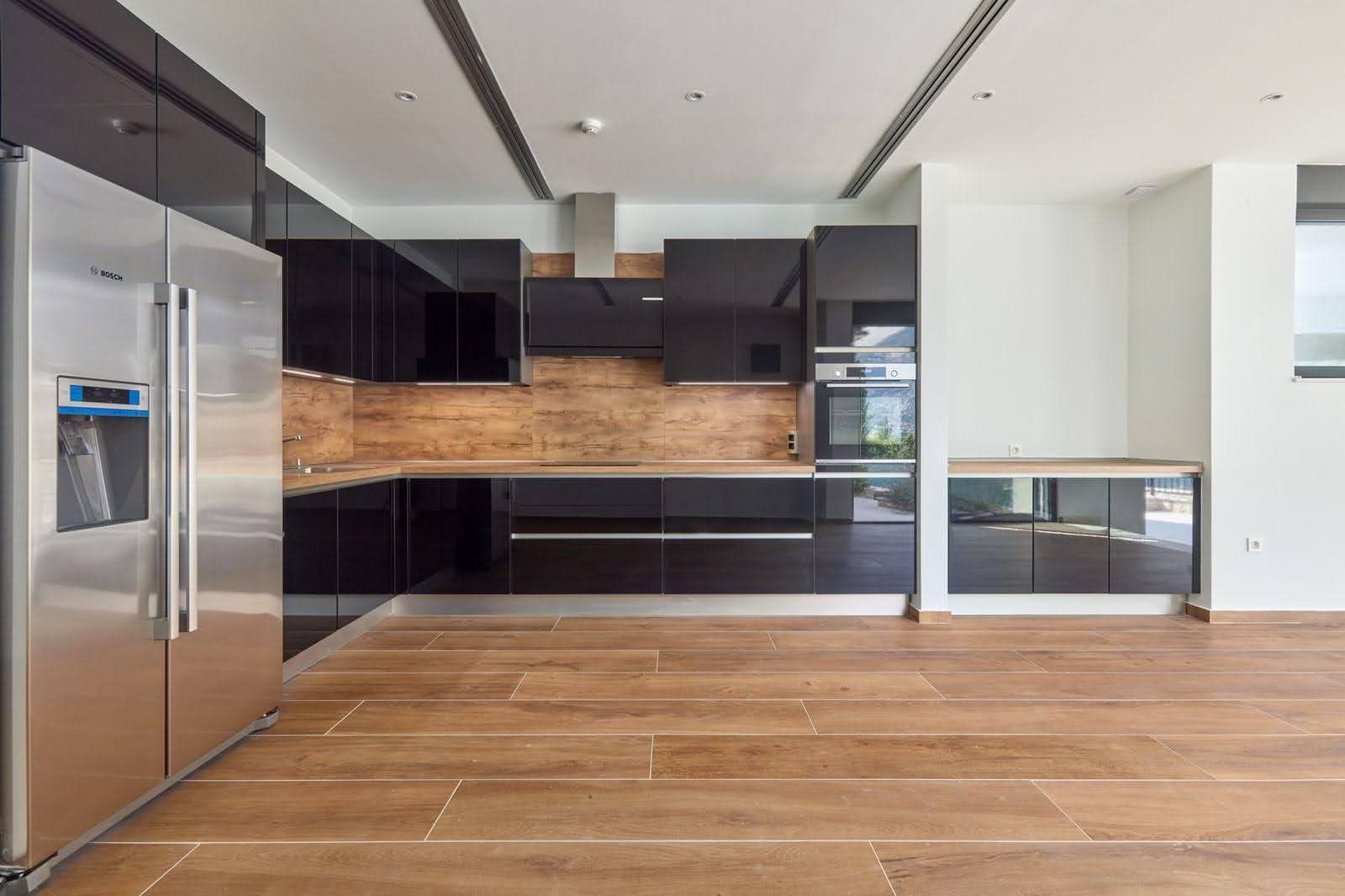Modern kitchen with black glossy fronts and Bosch appliances in a villa in Prčanj, Montenegro.