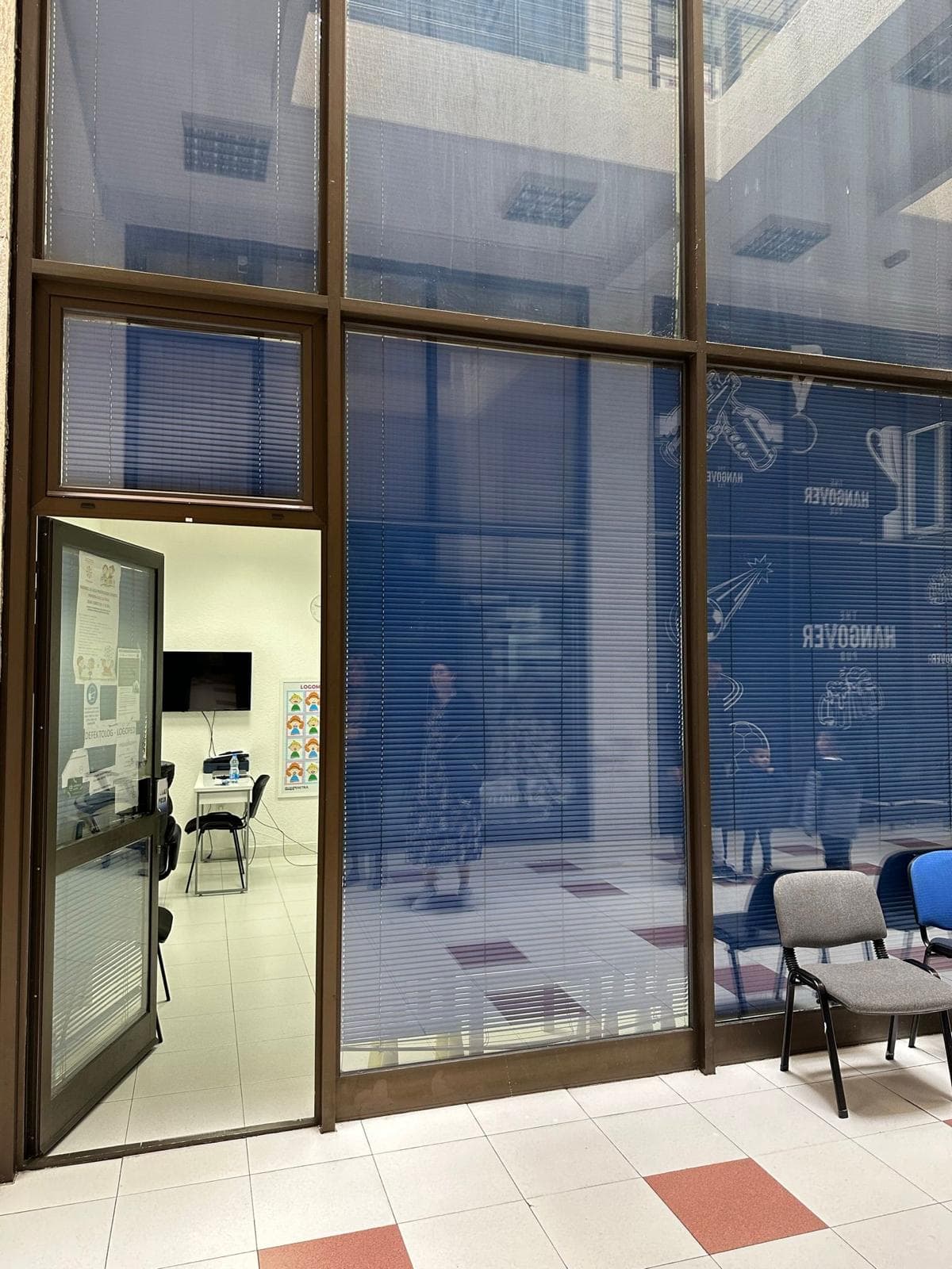Commercial premises in Bar, Montenegro: entrance area with panoramic glazing and an office room with furniture.