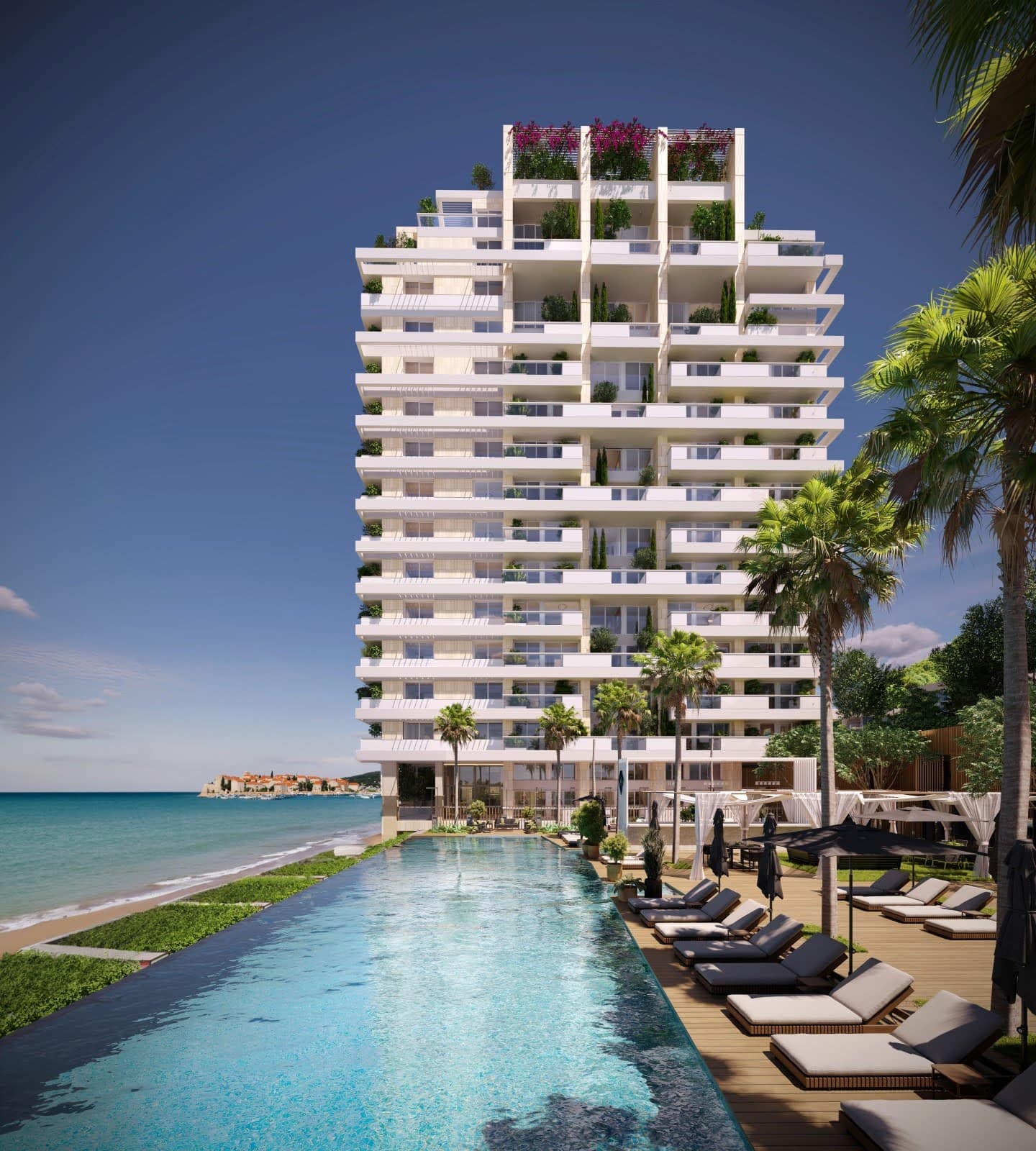 Modern residential complex with an infinity pool on the seafront in Budva, Montenegro, overlooking the island of Sveti Stefan.