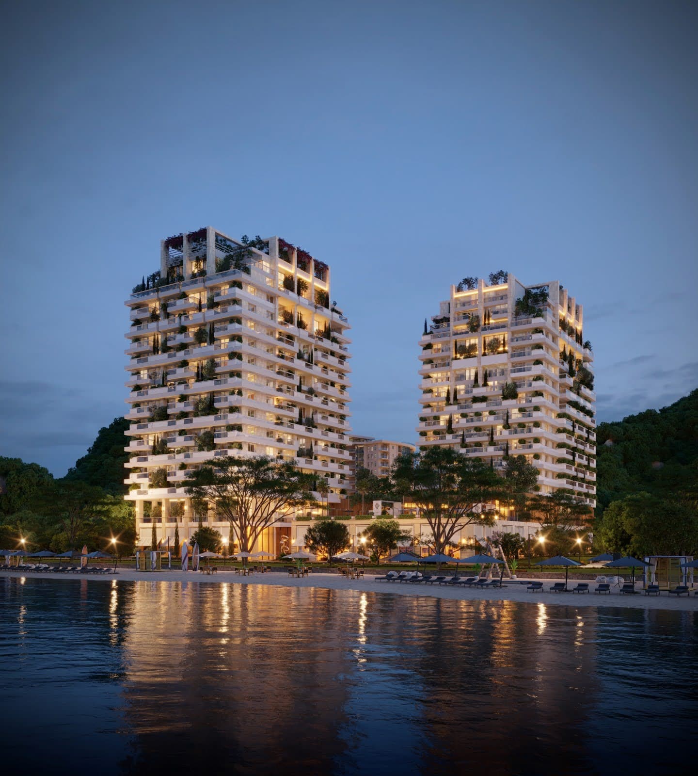 Modern residential complex with terraces and landscaping by the sea in Budva, Montenegro: evening view of luxury apartments.