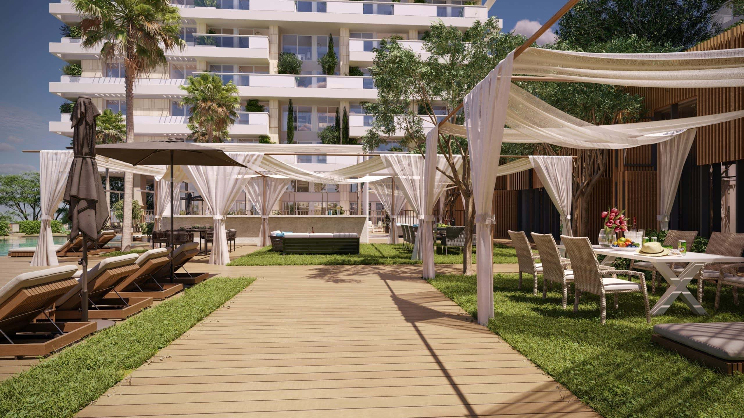 Recreation area with sun loungers and gazebos by a modern residential complex in Budva, Montenegro: view of the pool and terrace.