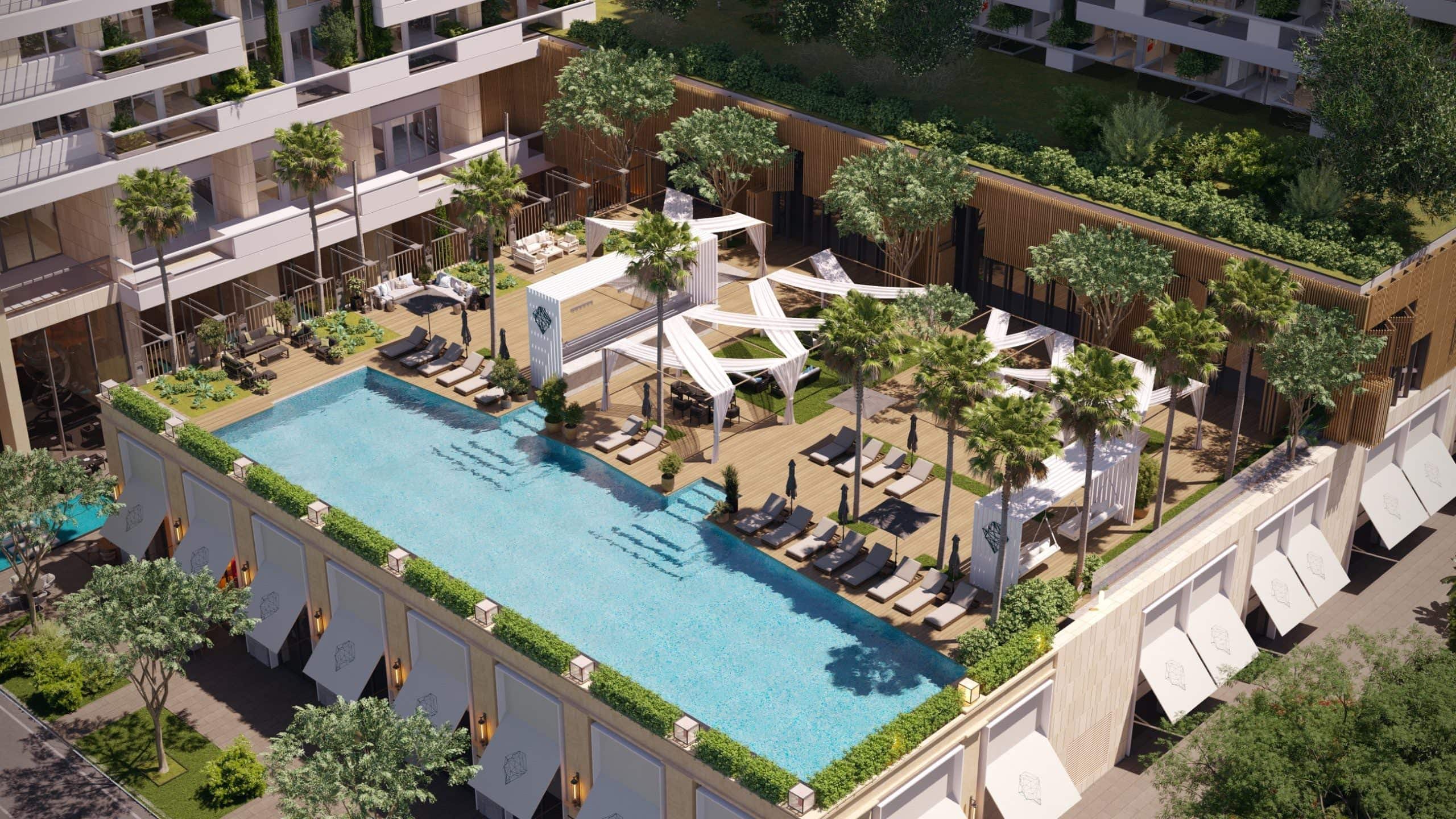 Outdoor swimming pool with sun loungers and relaxation areas in a premium residential complex in Budva, Montenegro.