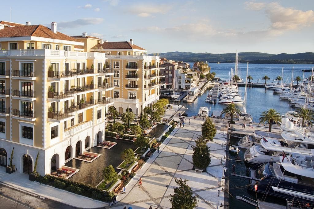 Luxury residential complex by the yacht marina in Porto Montenegro, Tivat, Montenegro: view of the waterfront promenade and buildings.