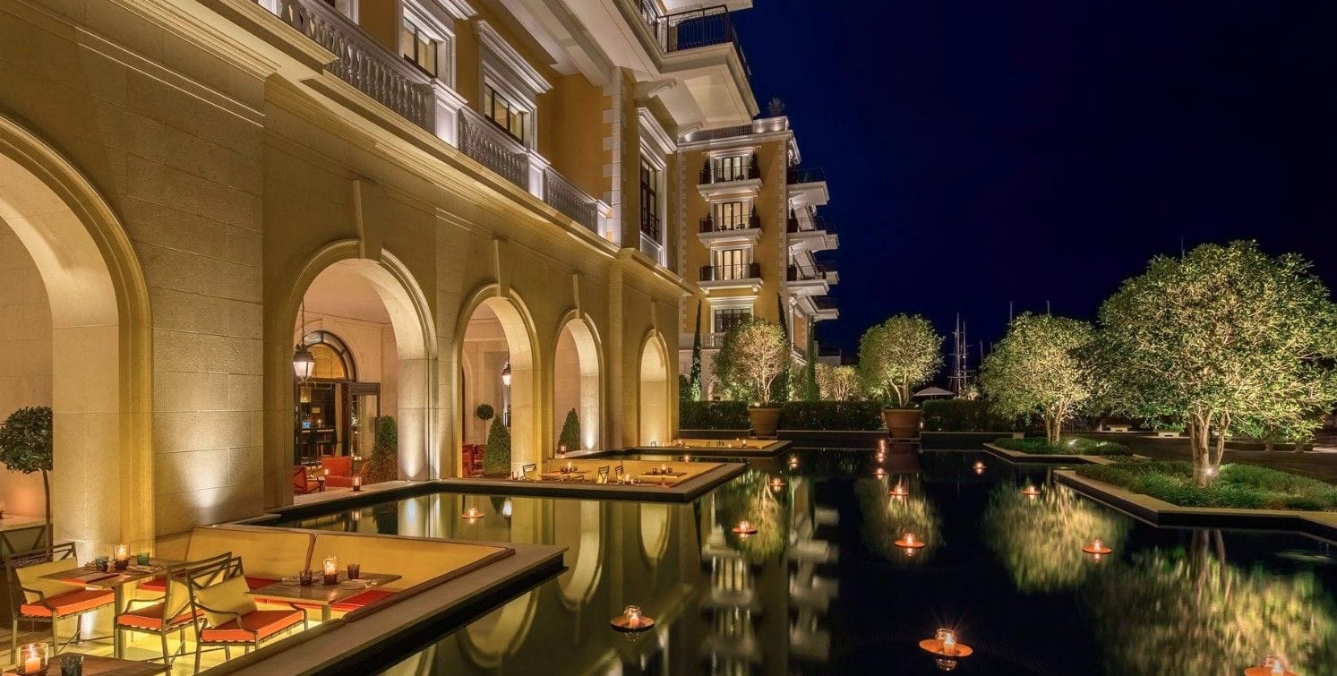Evening view of a luxury residential complex with a pool and lighting in Porto Montenegro, Tivat, Montenegro.
