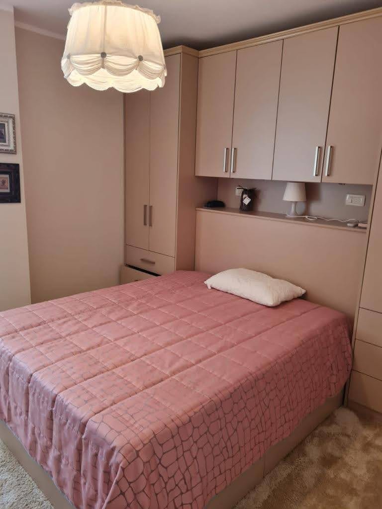 Cozy bedroom with a double bed and built-in wardrobe in an apartment in Petrovac, Montenegro.