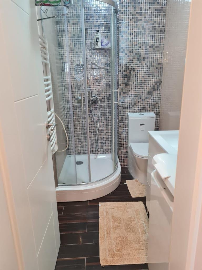 Bathroom in an apartment in Petrovac, Montenegro: shower cabin, mosaic tile, and modern fixtures.