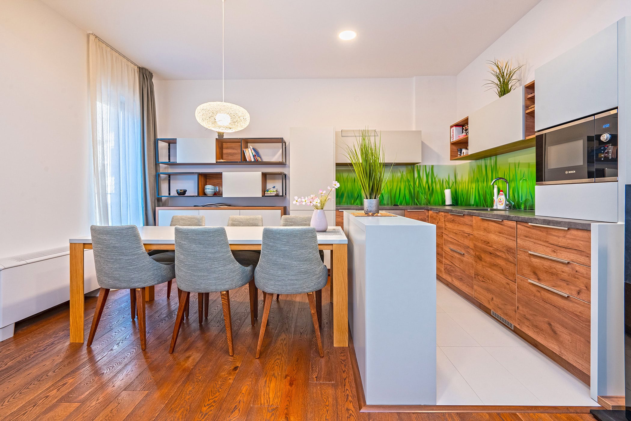 Modern kitchen-dining room in an apartment in Budva, Montenegro: wooden fronts, dining area, and stylish interior.