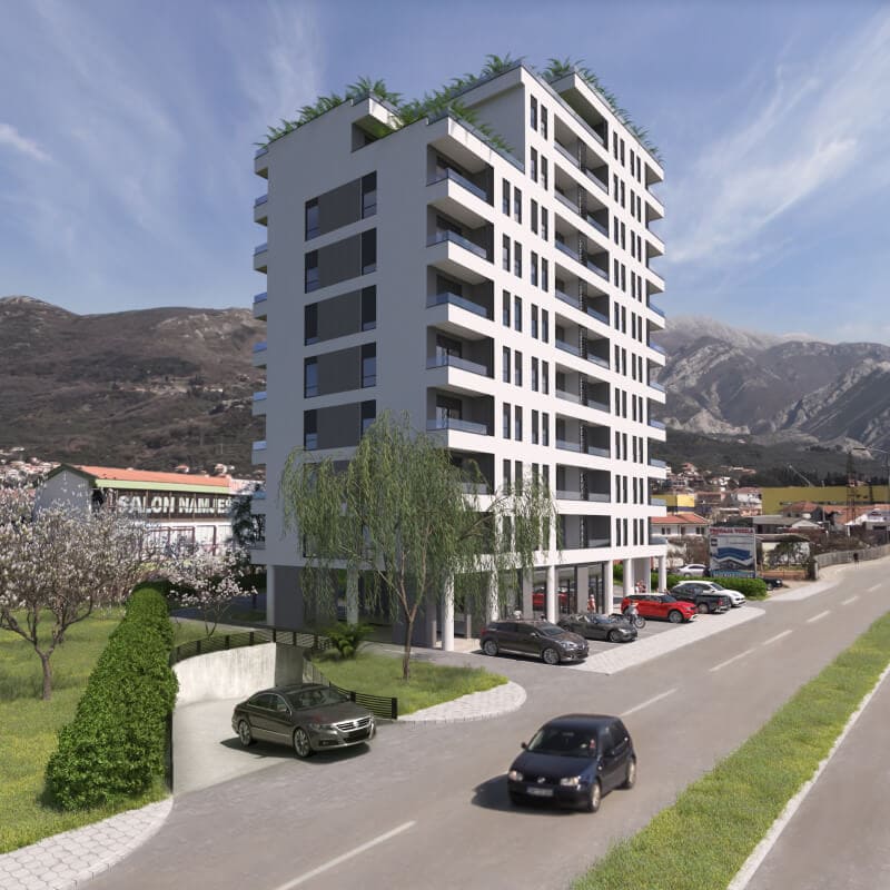 Modern residential complex in Bar, Montenegro: a multi-story building with balconies, parking, and mountain views.