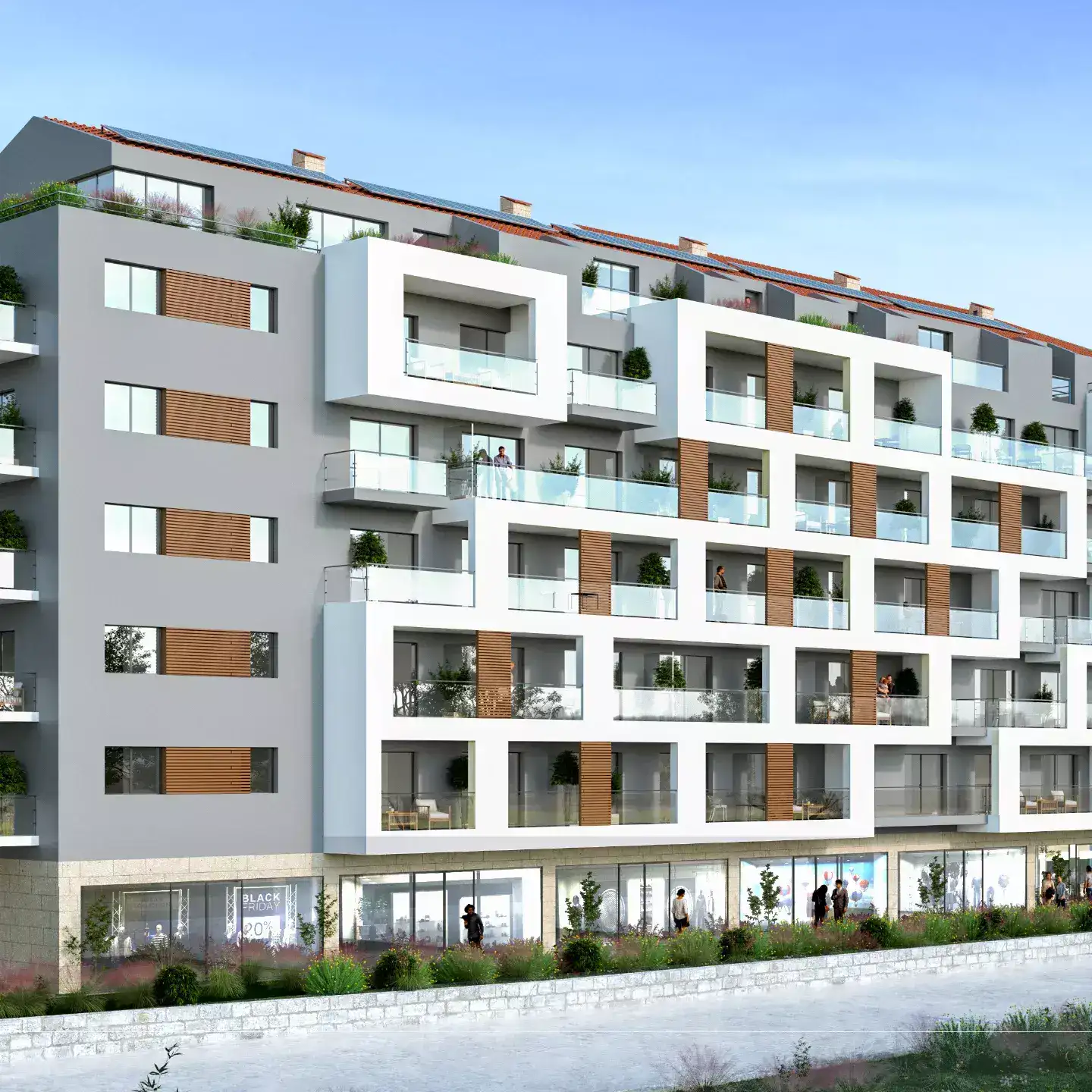 Modern residential complex in Budva, Montenegro: facade with terraces, panoramic windows, and commercial spaces.