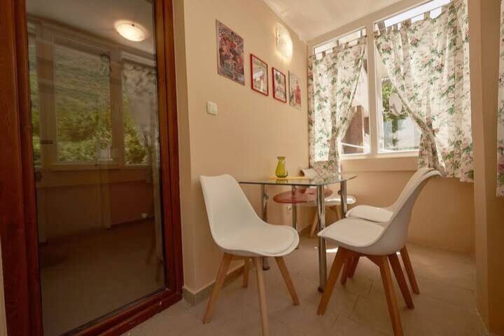 Cozy balcony with a dining area and panoramic windows in an apartment, Prčanj, Montenegro.
