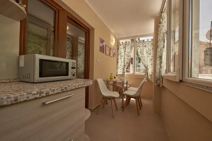 Cozy kitchen with dining area and panoramic windows in an apartment, Prčanj, Montenegro.