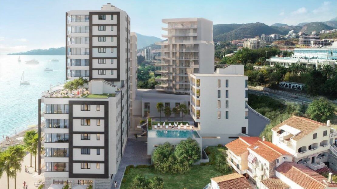Modern residential complex with a pool by the sea in Bečići, Montenegro: view of the architecture and landscaped grounds.