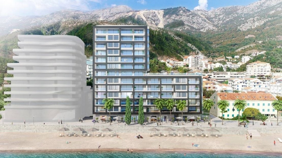 Modern residential complex on the seafront in Bečići, Montenegro: view of the building with panoramic terraces and the beach.