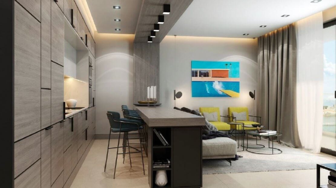 Modern living room with an island kitchen in an apartment in Bečići, Montenegro: stylish furniture, panoramic window, decor.