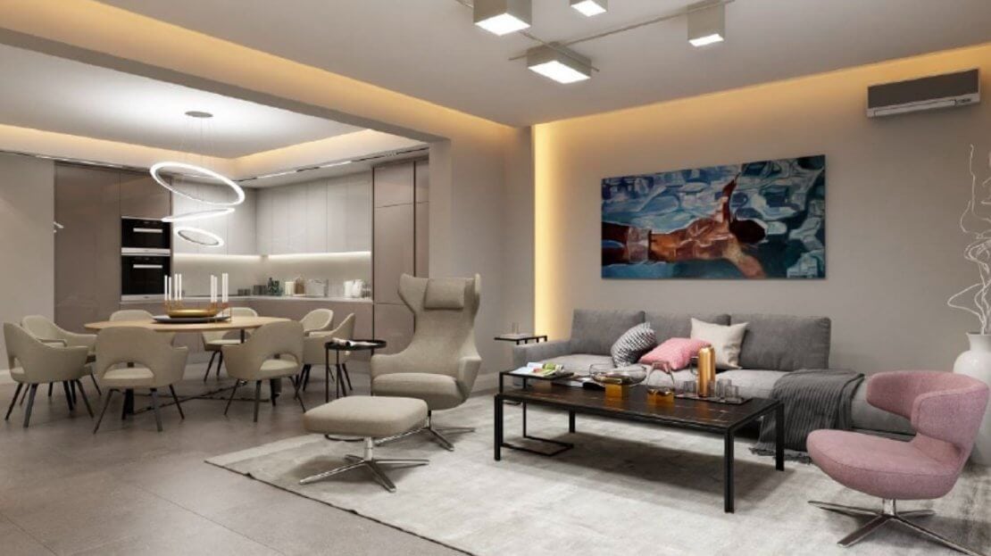 Modern living room with kitchen in an apartment in Bečići, Montenegro: stylish furniture, a soft sofa, and a dining area.