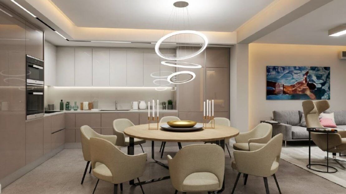 Modern kitchen-living room with dining area in an apartment, Becici, Montenegro: light furniture and stylish decor.