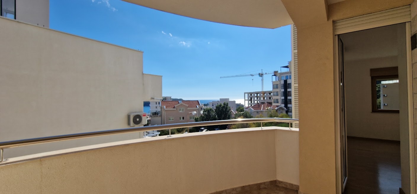 View from the apartment balcony in Becici, Budva Riviera, Montenegro: panoramic view of the city, the sea, and the modern terrace finish.
