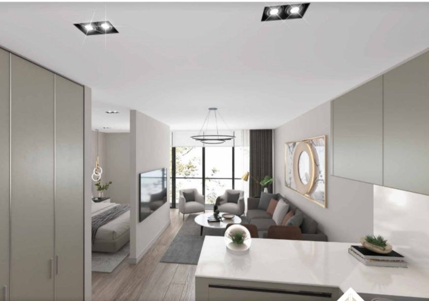 Modern living room with kitchen in a residential complex in Bar, Montenegro: stylish interior, panoramic windows, and high-quality finishes.