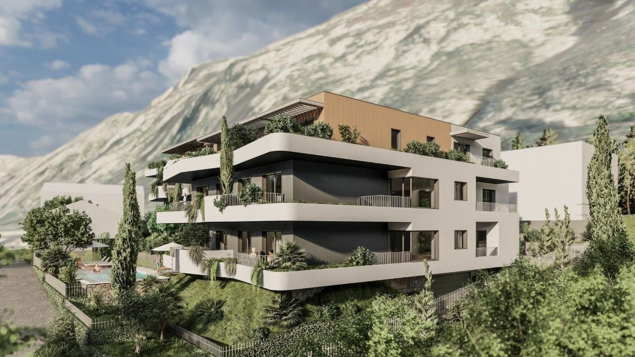 Modern residential complex in Dobrota, Montenegro: view of the building with terraces, a swimming pool, and mountain scenery.