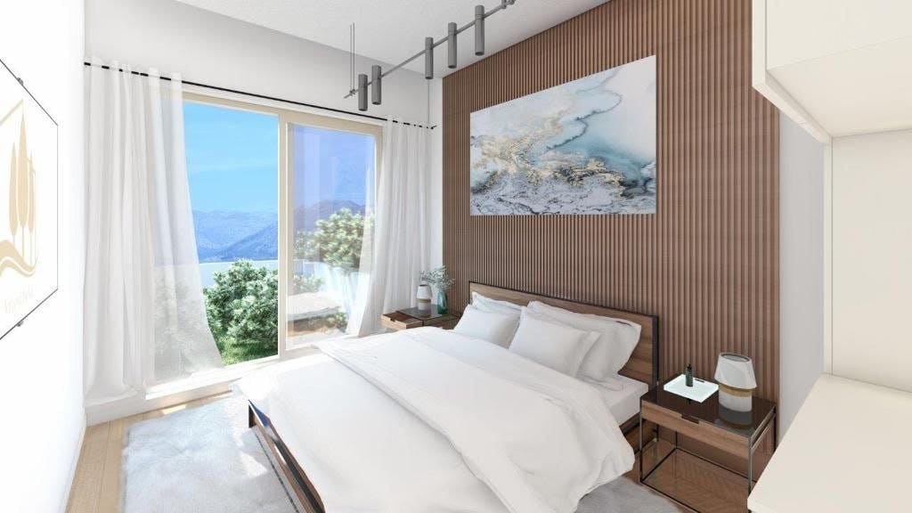 Modern bedroom with panoramic sea view in Dobrota residential complex, Montenegro: slatted wall, double bed, and decor.