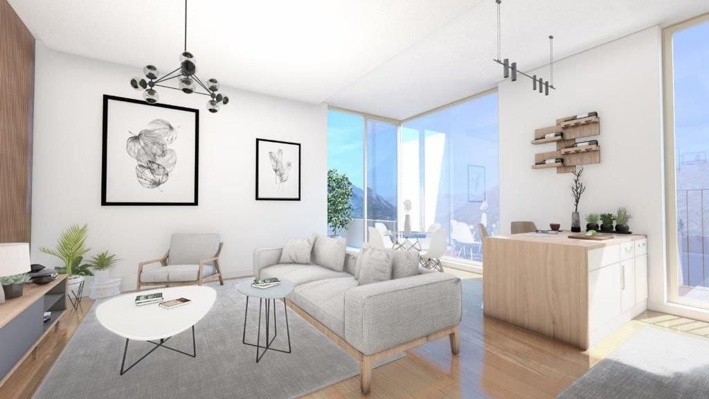 Modern living room in Dobrota residential complex, Montenegro: bright interior, panoramic windows, stylish furniture, and mountain views.