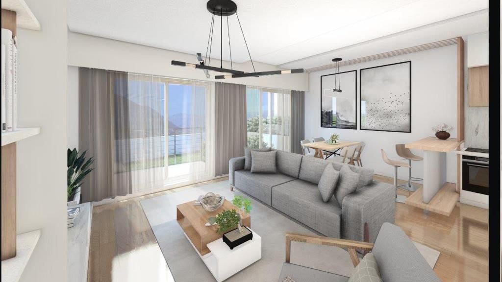 Modern living room with panoramic views in the Dobrota residential complex, Montenegro: stylish furniture, kitchen, and bright interior.