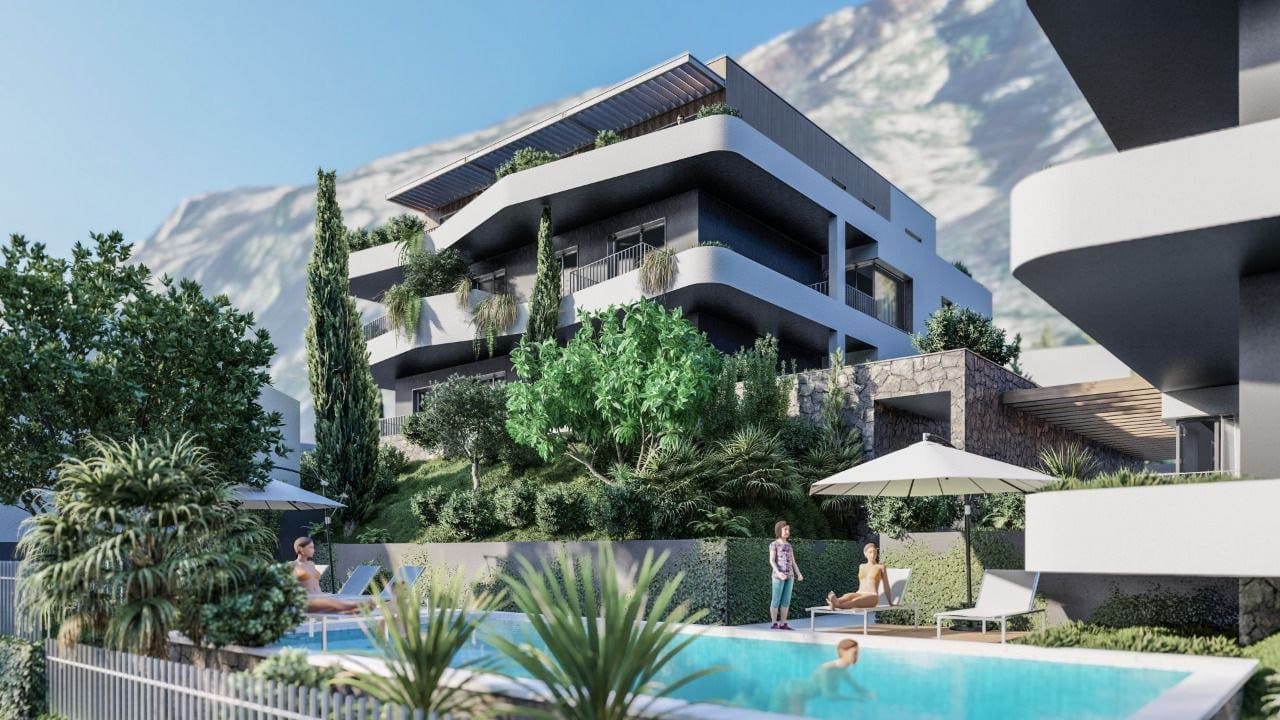 Modern residential complex in Dobrota, Montenegro: swimming pool, landscaped terraces, and mountain views.