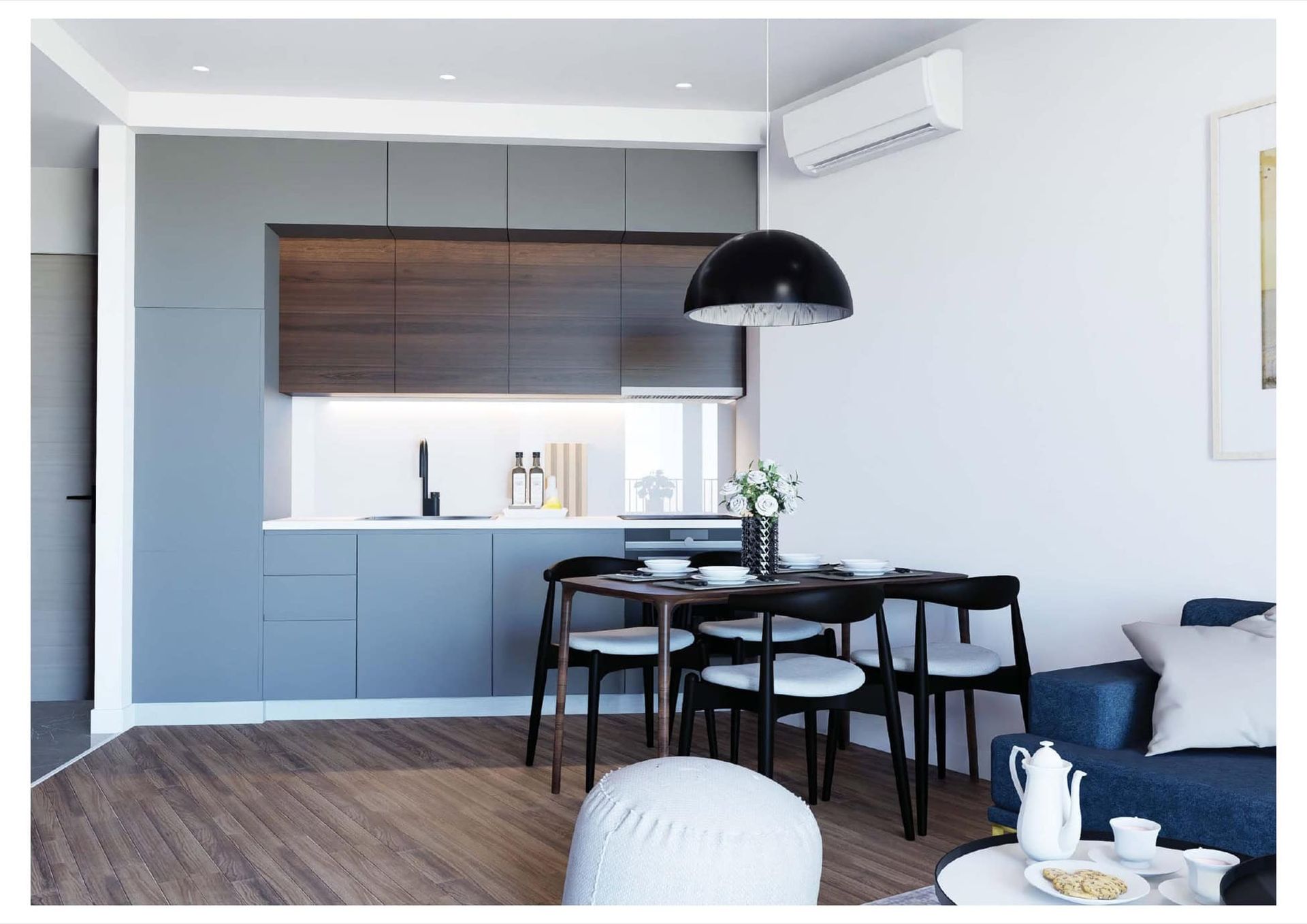 Modern kitchen-living room with dark cabinetry and a dining area in a residential complex in Bečići, Montenegro. Furnished interior.