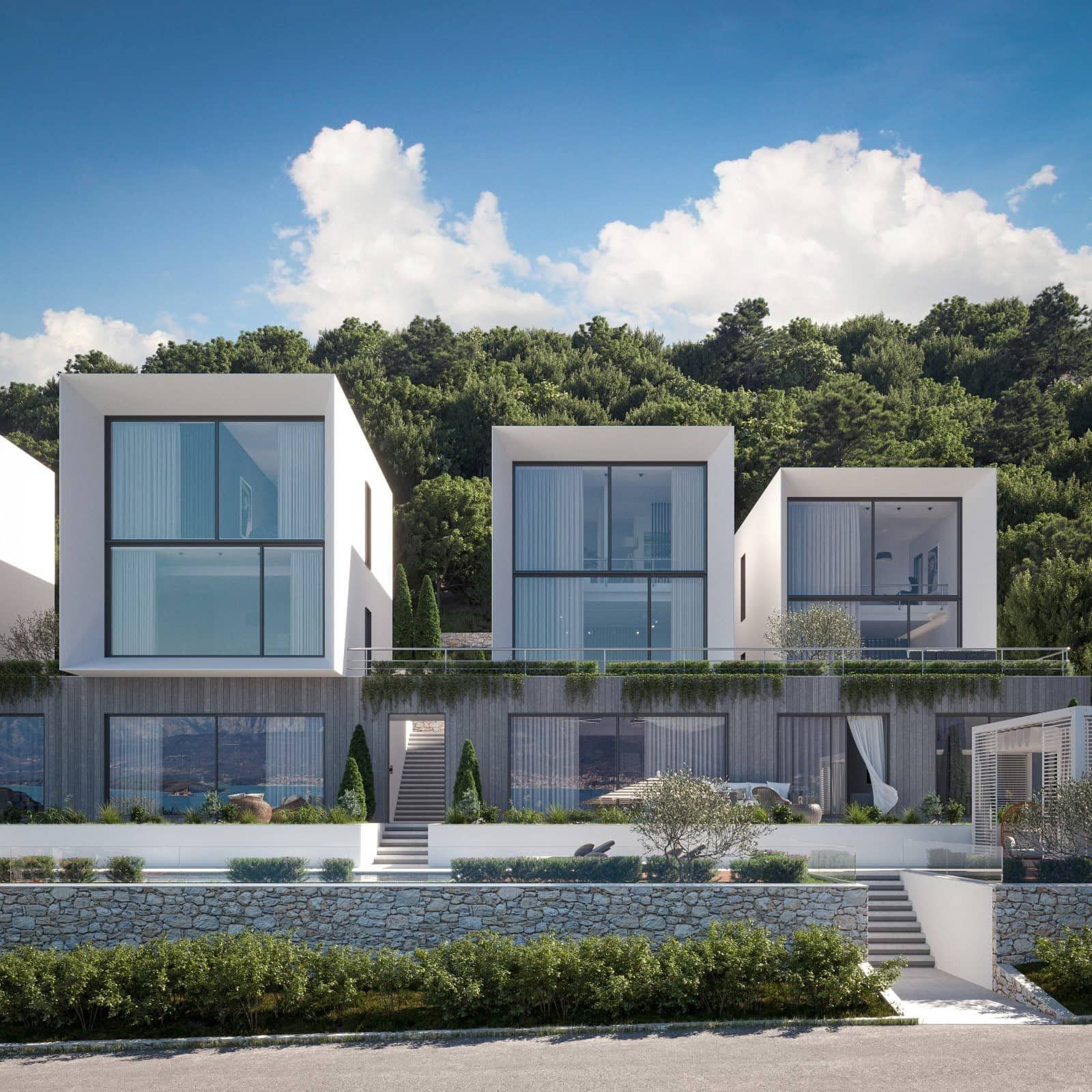 Modern villas in Krašići, Montenegro: panoramic glazing, terraces, and sea views surrounded by greenery.
