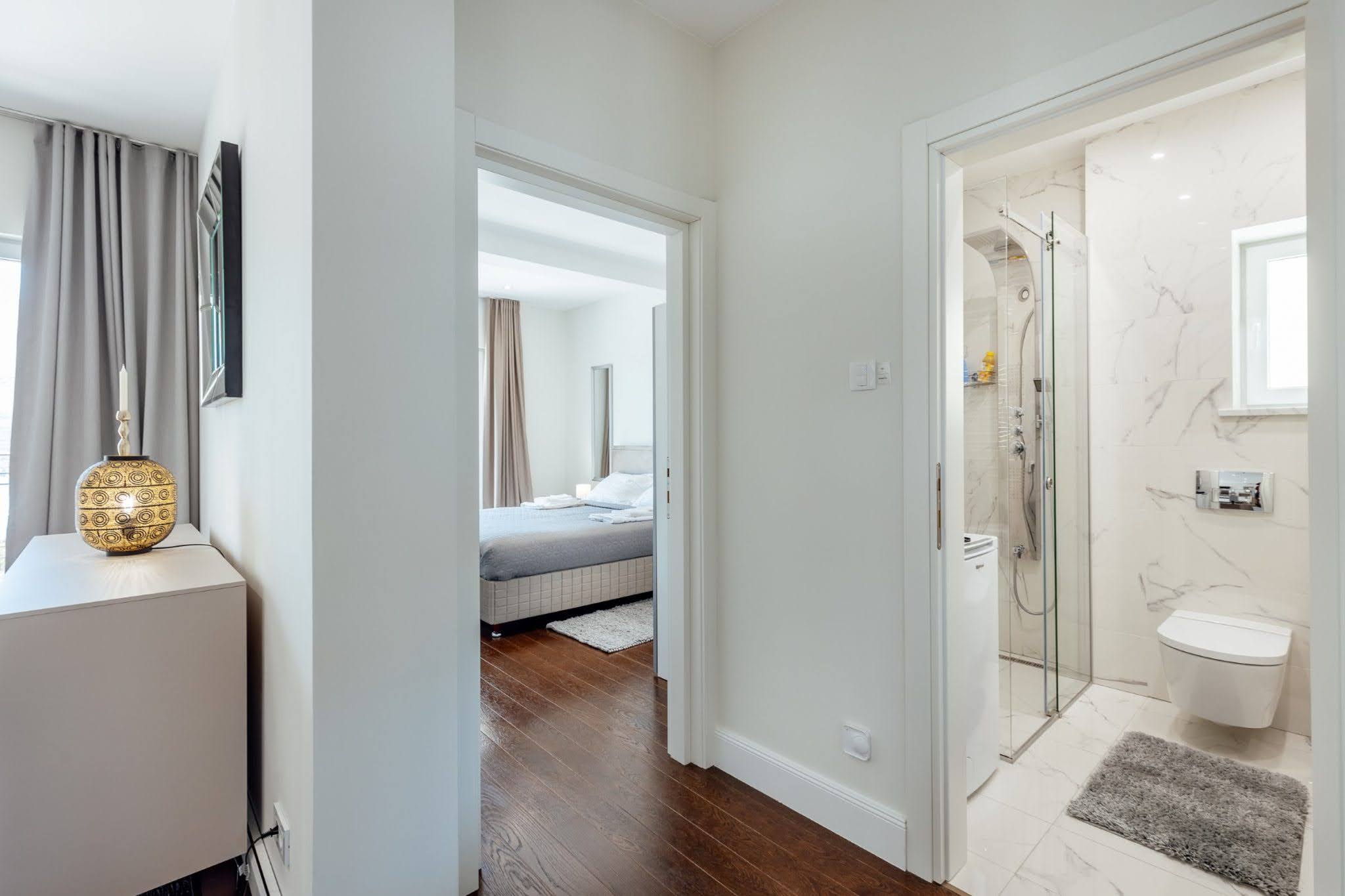 Interior of an apartment in Kumbor, Montenegro: view of a modern bedroom and bathroom with light stone finishes.