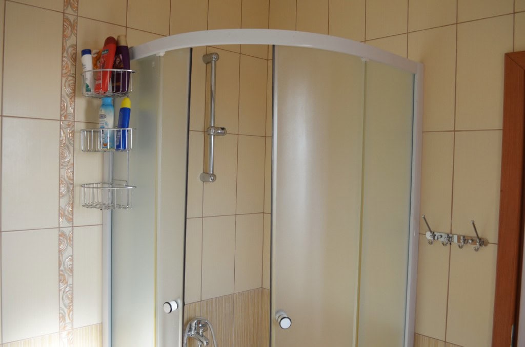 Bathroom with shower cabin in an apartment, Bar, Montenegro: beige tiles and sanitary ware.