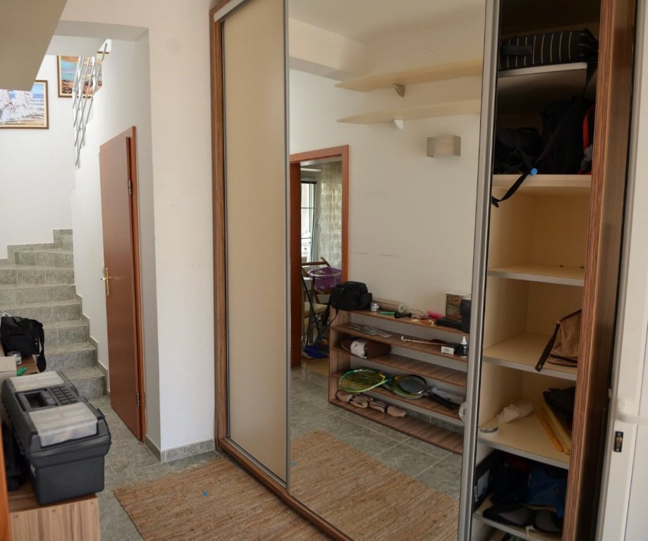 Hallway with a mirrored sliding wardrobe and staircase in a two-story apartment, Bar, Montenegro.