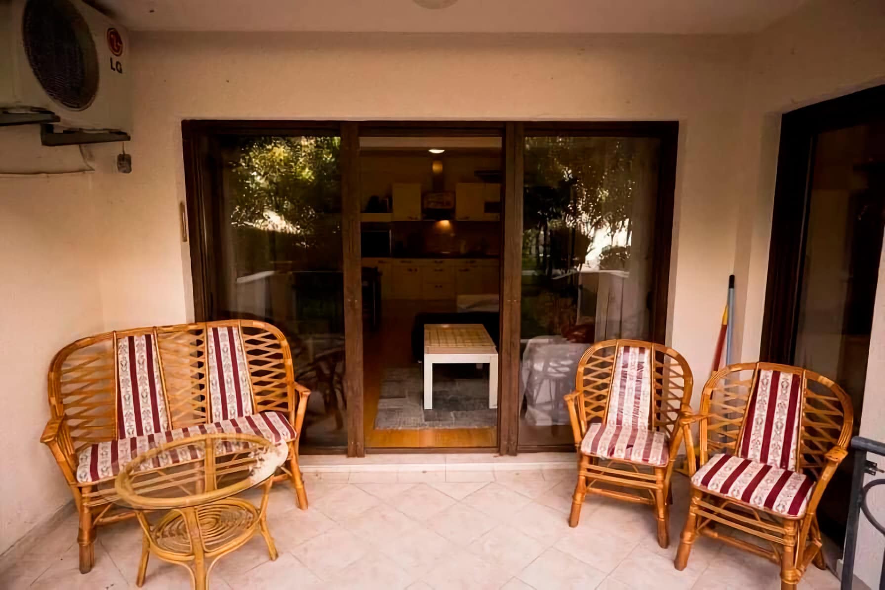 Cozy terrace with wicker furniture and a view of the living room in an apartment, Budva, Montenegro.