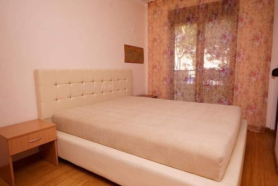 Cozy bedroom with a double bed and access to the balcony in an apartment in Budva, Montenegro.