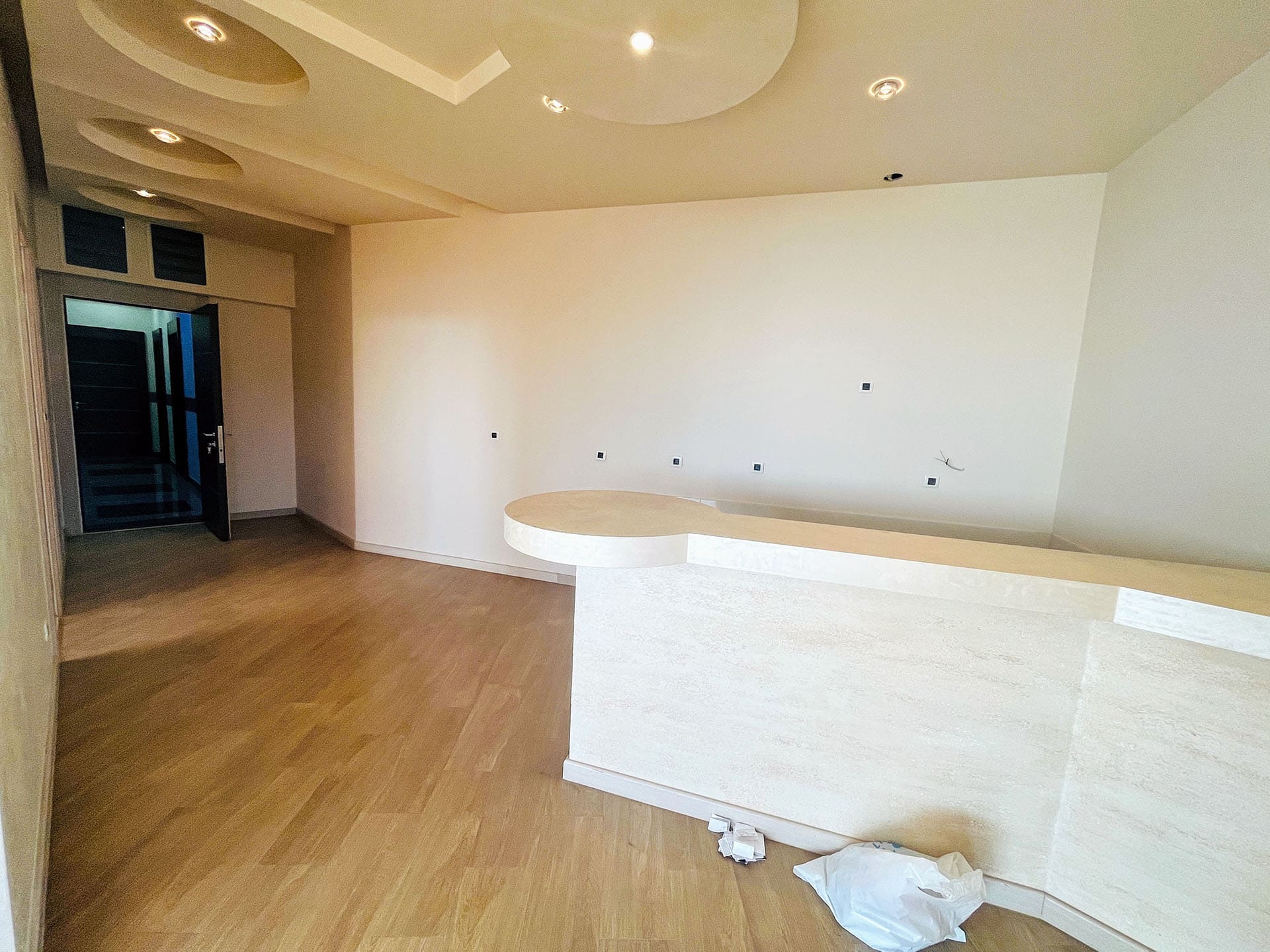 Modern living room with a bar counter and designer ceiling in an apartment, Budva, Montenegro.