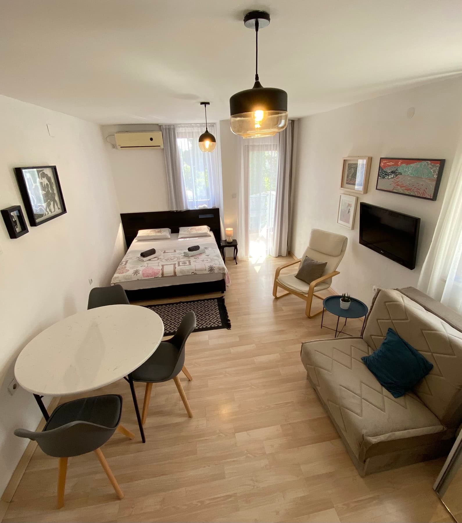 Cozy bedroom with a double bed and seating area in a house, Shushan, Montenegro: modern furniture and a bright interior.