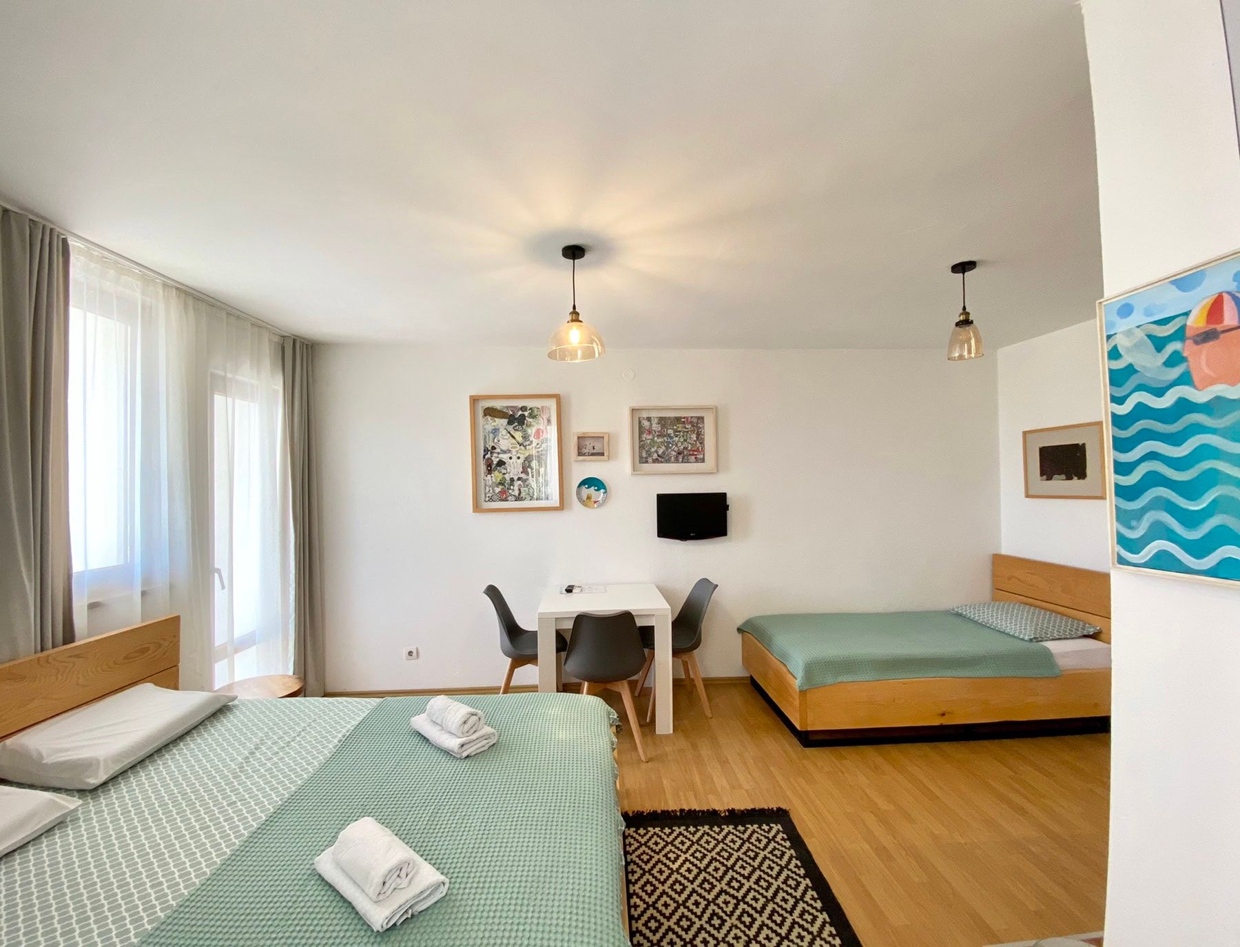 Bright bedroom with two wooden beds in a house, Shushan, Montenegro: modern furniture and a panoramic window.