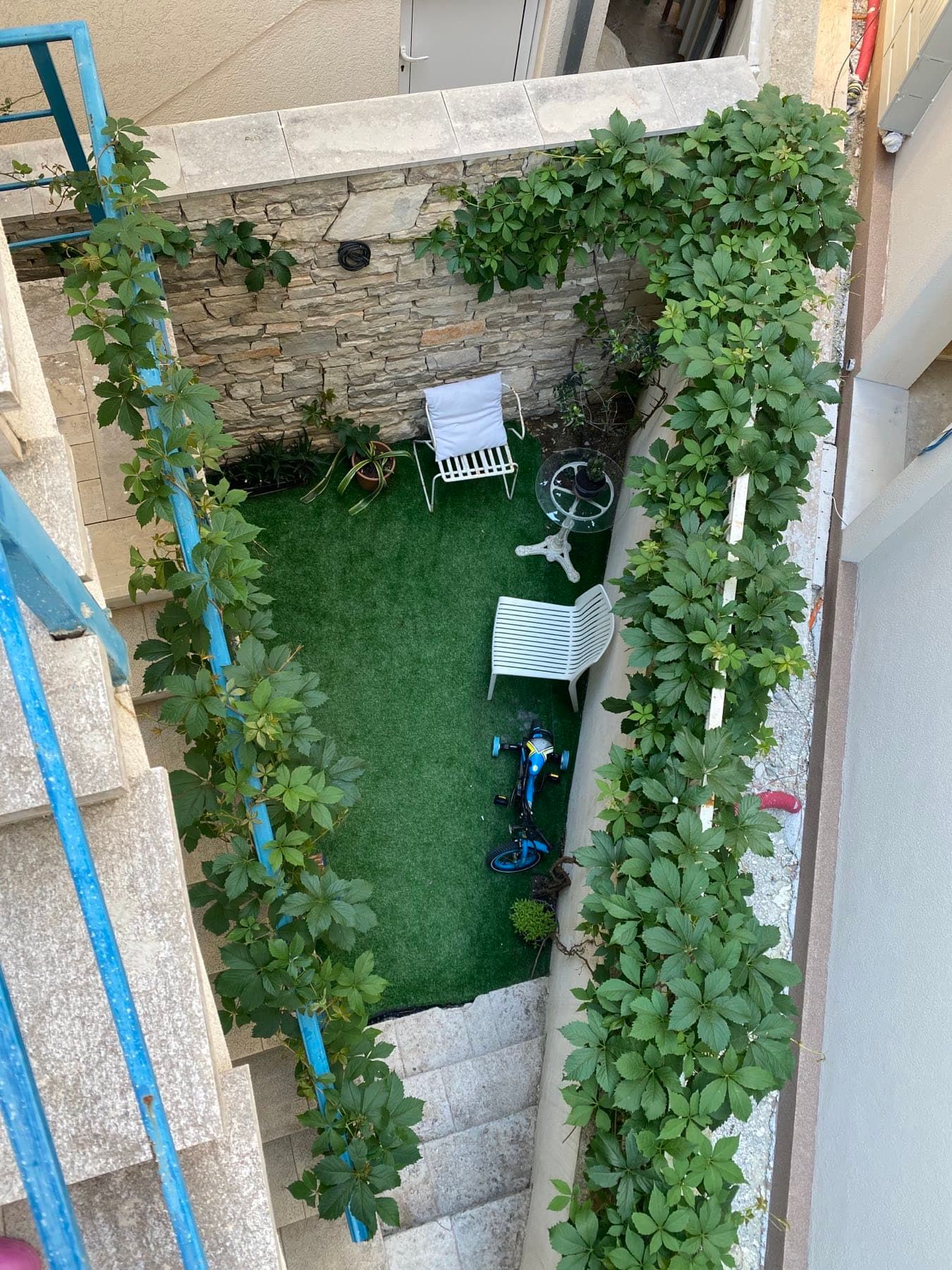 Cozy courtyard with artificial grass and garden furniture in a house, Shushan, Montenegro.