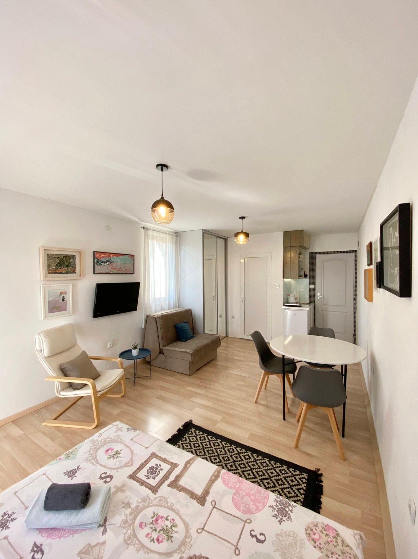 Living room with dining area and kitchen in a house, Shushan, Montenegro: bright interior, modern furniture and decor.