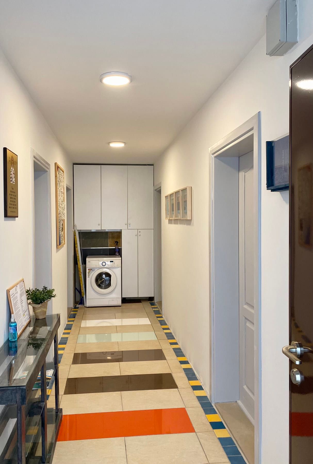 Bright hallway with tile and a built-in closet with a washing machine in a house, Shushan, Montenegro.