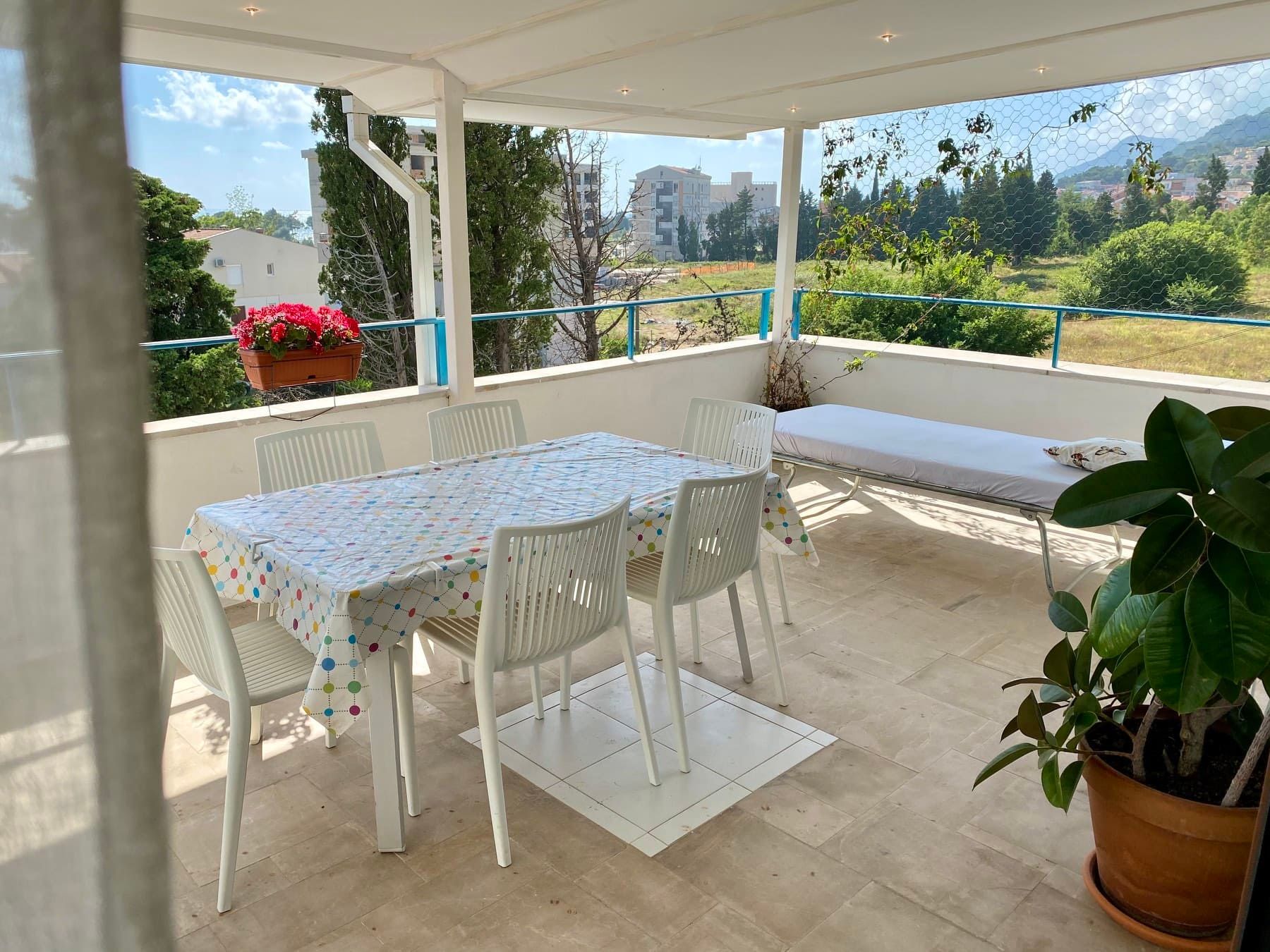 Spacious terrace with dining area and mountain views in a house, Shushan, Montenegro: light furniture and a cozy atmosphere.