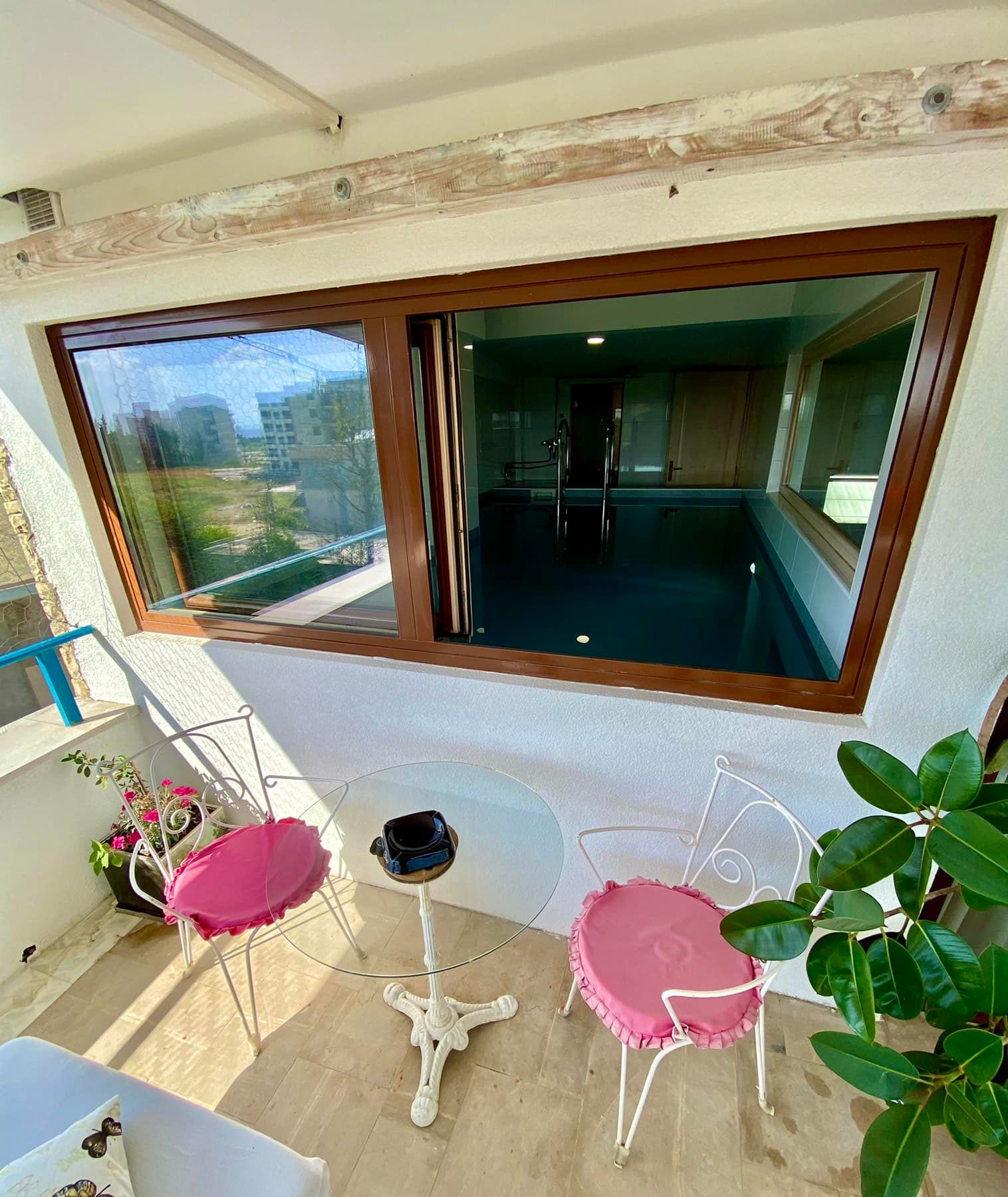 Balcony with wrought-iron furniture and a view of the indoor pool in the house, Shushan, Montenegro.
