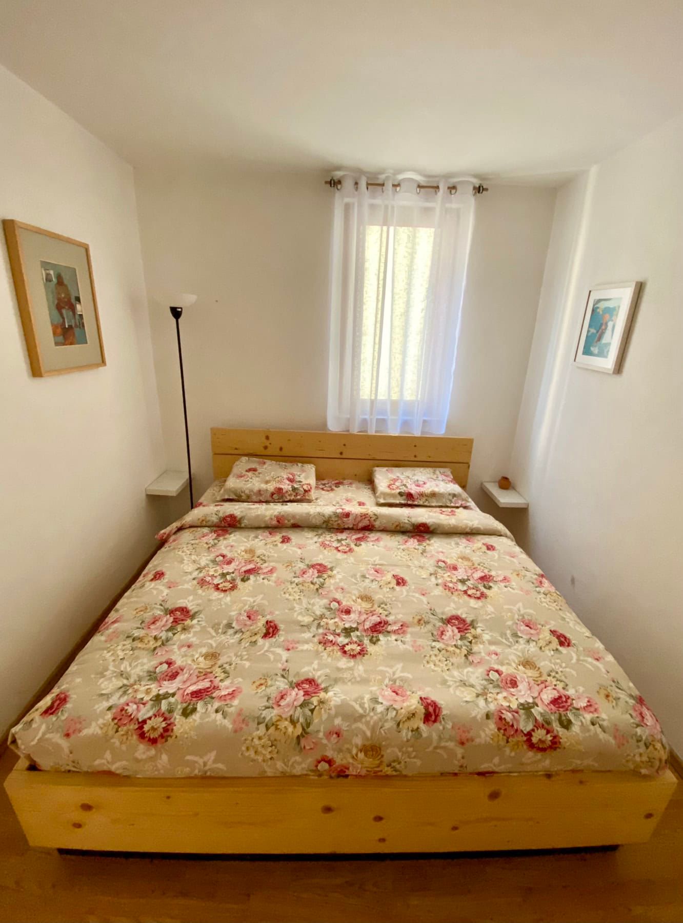 Cozy bedroom with a double bed in a house, Shushan, Montenegro: bright interior, wooden furniture.
