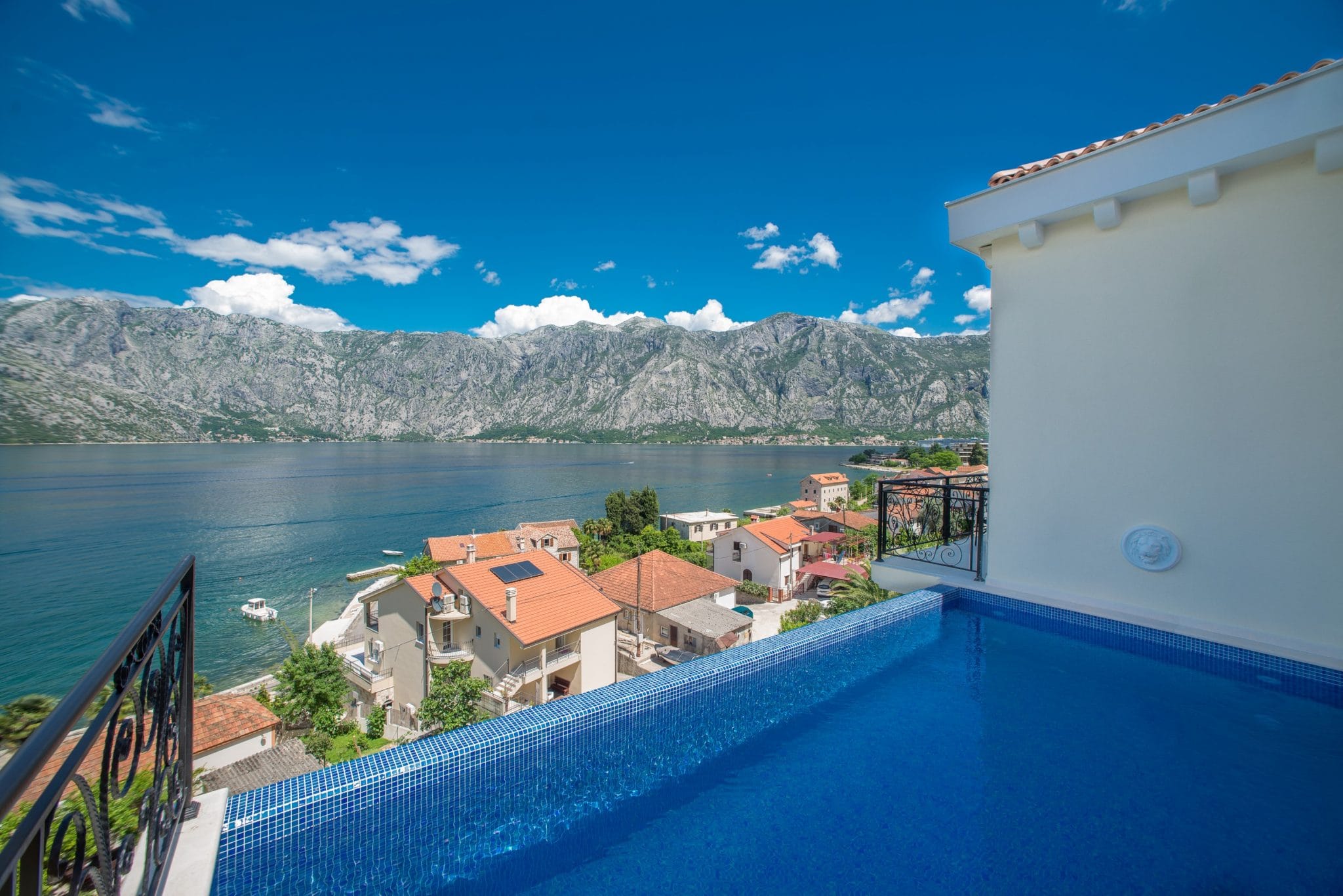 Infinity pool on the villa terrace in Stoliv, Montenegro, with panoramic views of the Bay of Kotor and the mountains.