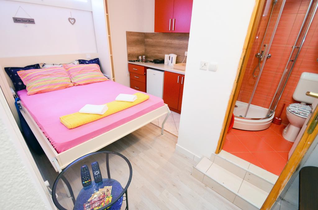 Cozy studio with a double bed, kitchenette, and shower in a house in Kotor, Montenegro.