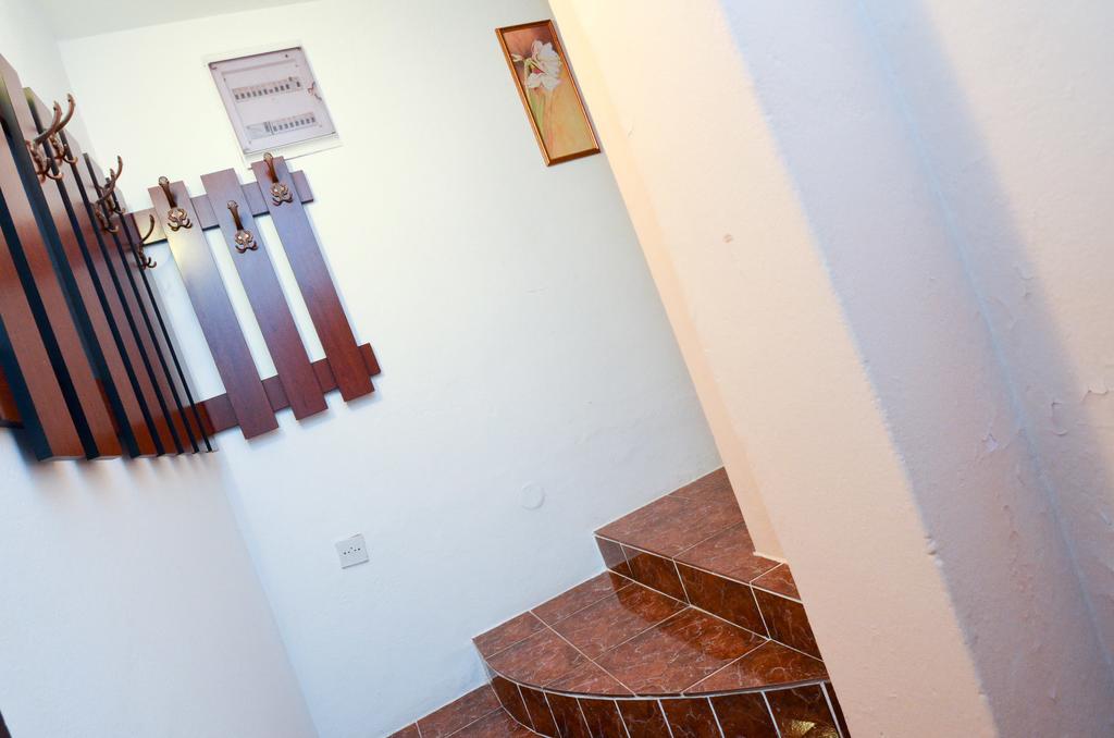 Hallway with a wooden coat rack and a tiled staircase in a house for sale, Kotor, Montenegro.