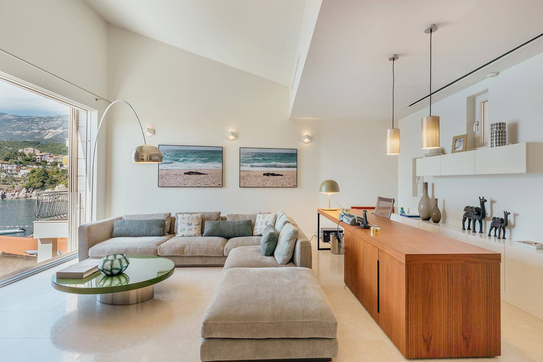 Modern living room in a villa in Pržno, Montenegro: bright interior, panoramic sea view, and designer furniture.