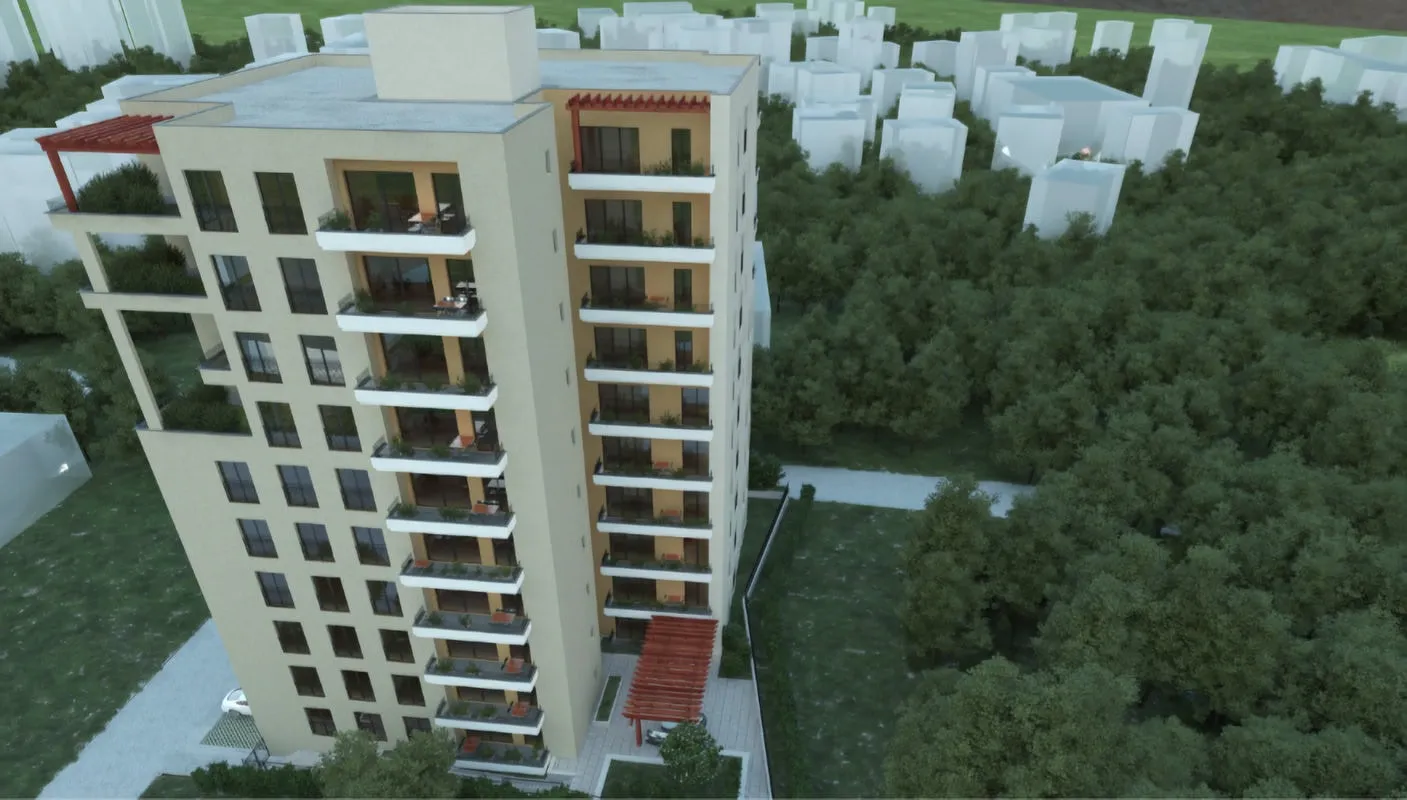 Aerial view of a multi-story residential building with balconies surrounded by trees and green spaces.