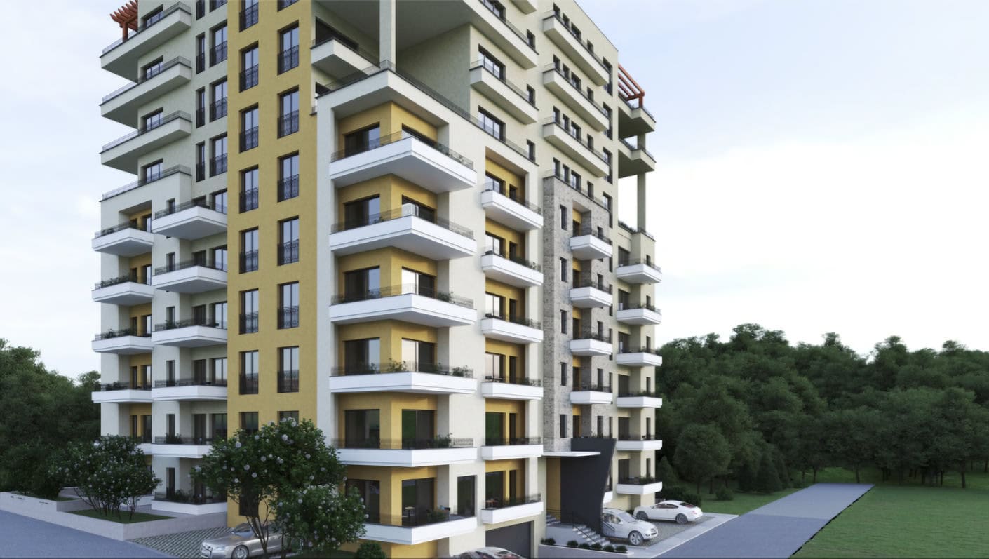 Modern residential complex in Budva, Montenegro: building facade with balconies and parking lot against a forest backdrop.
